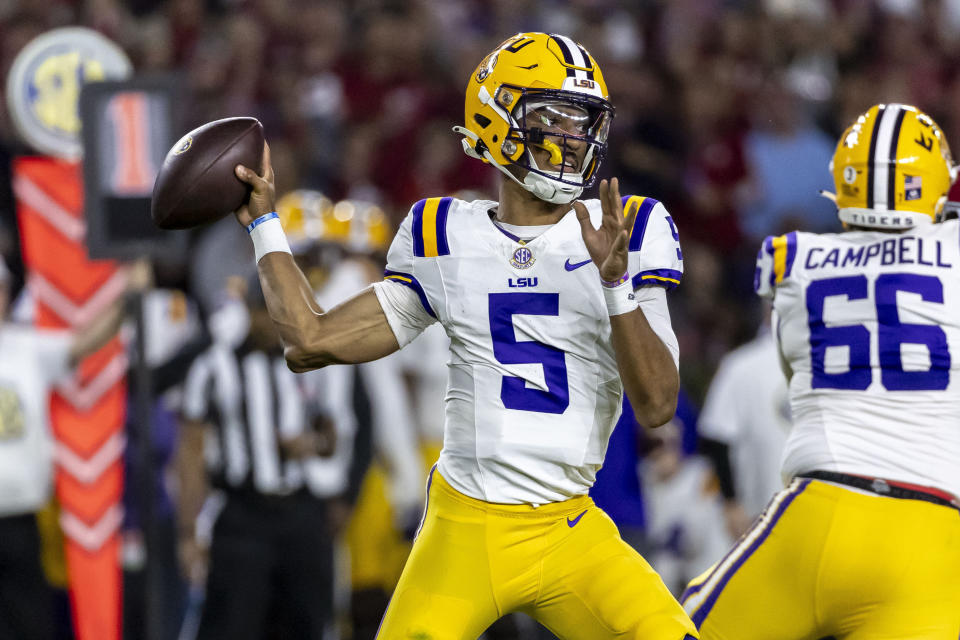 FILE - LSU quarterback Jayden Daniels (5) throws a passduring the first half of an NCAA college football game, against Alabama Saturday, Nov. 4, 2023, in Tuscaloosa, Ala. Daniels is a finalists for the Heisman Trophy. (AP Photo/Vasha Hunt, File)