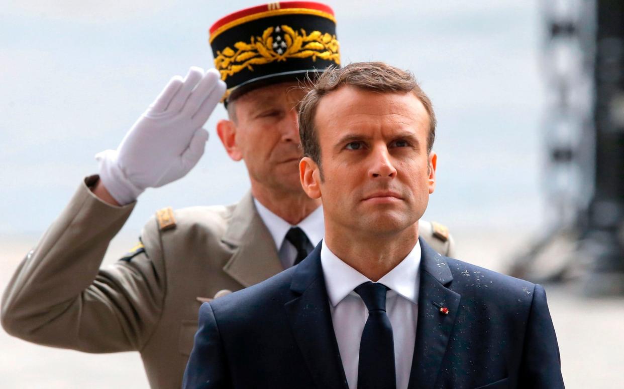 This file photo taken on May 14, 2017 shows French President Emmanuel Macron observing a minute of silence in front of Chief of the Defence Staff French army General Pierre de Villiers (L) after laying a wreath on the unknown Soldier's tomb at the Arc of Triomphe monument, after his formal inauguration ceremony in Paris - AFP