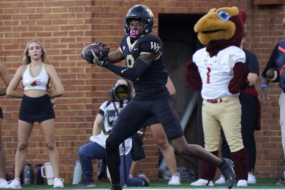 Wake Forest wide receiver Wesley Grimes (8) catches a touchdown pass against Elon during the first half of an NCAA college football game in Winston-Salem, N.C., Thursday, Aug. 31, 2023. (AP Photo/Chuck Burton)