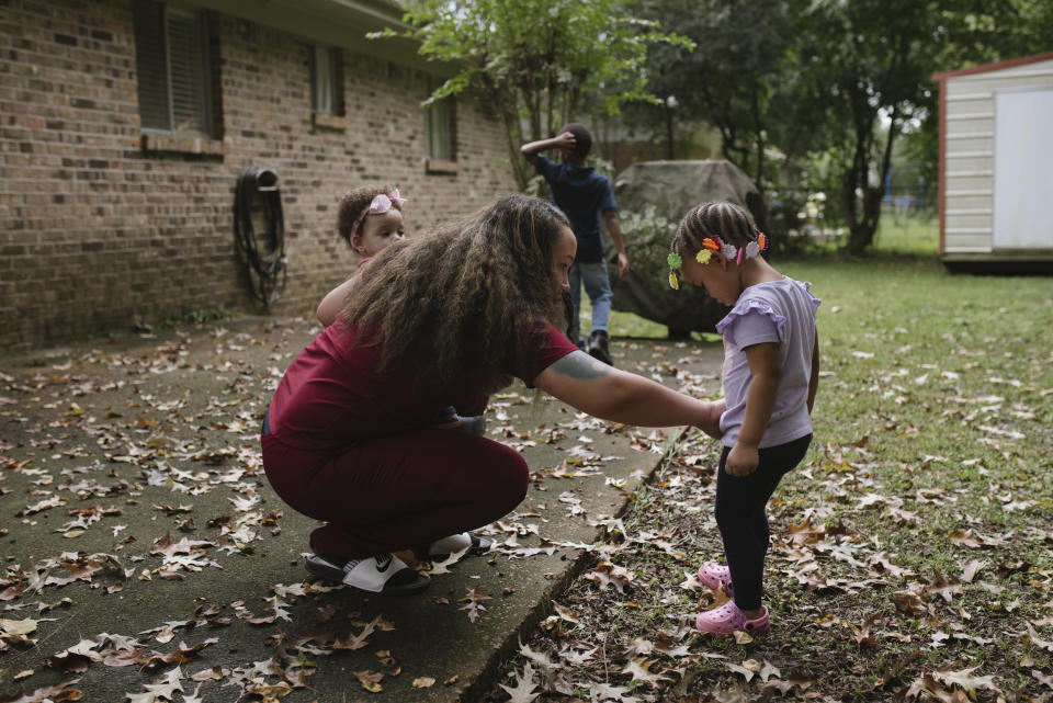 Brown dusts off her daughter Emery after she fell in the garden. (Lucy Garrett for NBC News)