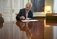 Finnish Foreign Minister Pekka Haavisto signs a petition for NATO membership application in Helsinki, Tuesday, May 17, 2022. Sweden and Finland on Tuesday pushed ahead with their bids to join NATO even as Turkey insisted it won’t let the previously non-aligned Nordic countries into the alliance because of their alleged support for Kurdish militants. (Annti Aimo-Koivisto/Lehtikuva via AP)