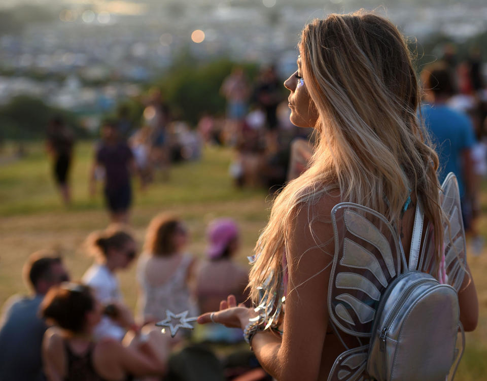 <p>Festival goers watch the sun set at the Glastonbury Festival of Music and Performing Arts on Worthy Farm near the village of Pilton in Somerset, South West England, on June 21, 2017. (Photo: Oli Scarff/AFP/Getty Images) </p>