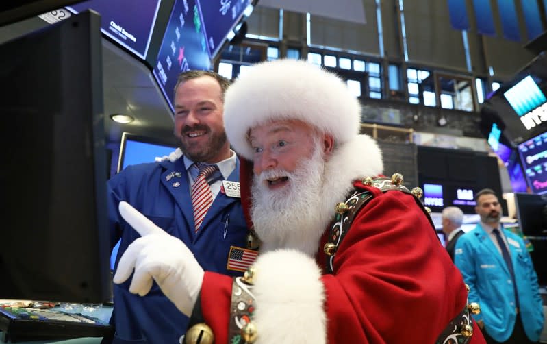 FILE PHOTO: Santa Claus pays a visit on the floor at the New York Stock Exchange (NYSE) in New York