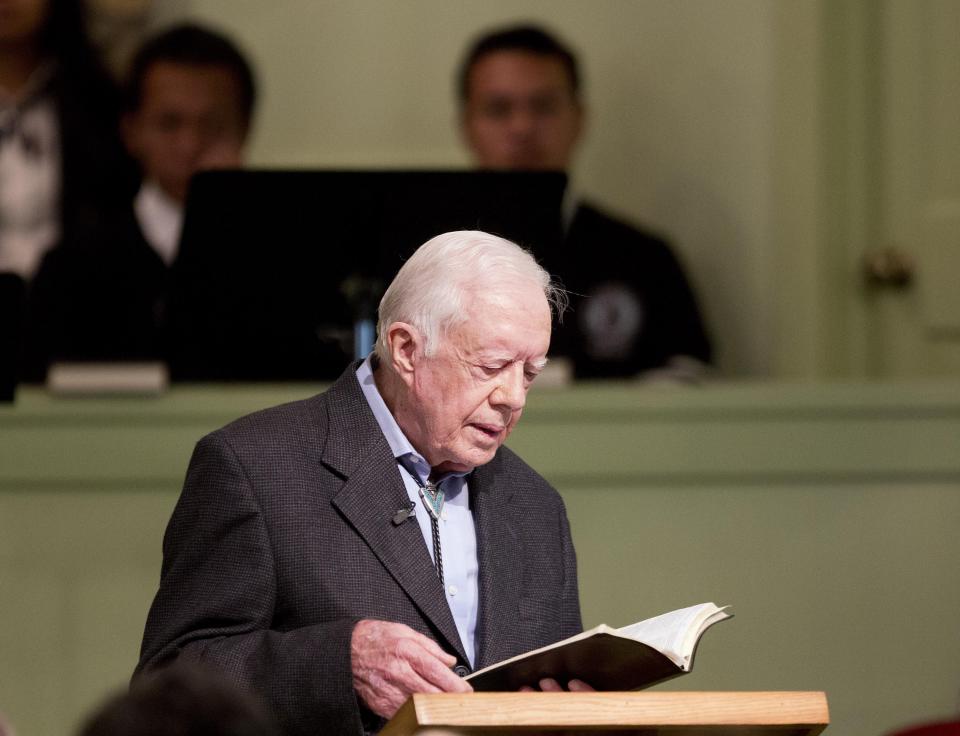 Former President Jimmy Carter opens up a Bible while teaching Sunday School class at the Maranatha Baptist Church in his hometown Sunday, Aug. 23, 2015, in Plains, Ga. (AP Photo/David Goldman)