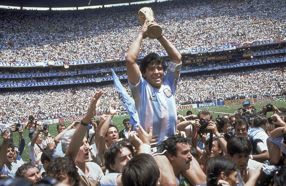 FILE - Diego Maradona, holds up the trophy, after Argentina beat West Germany 3-2 in the World Cup soccer final match, at the Atzeca Stadium, in Mexico City on June 29, 1986. (AP Photo/Carlo Fumagalli, File)
