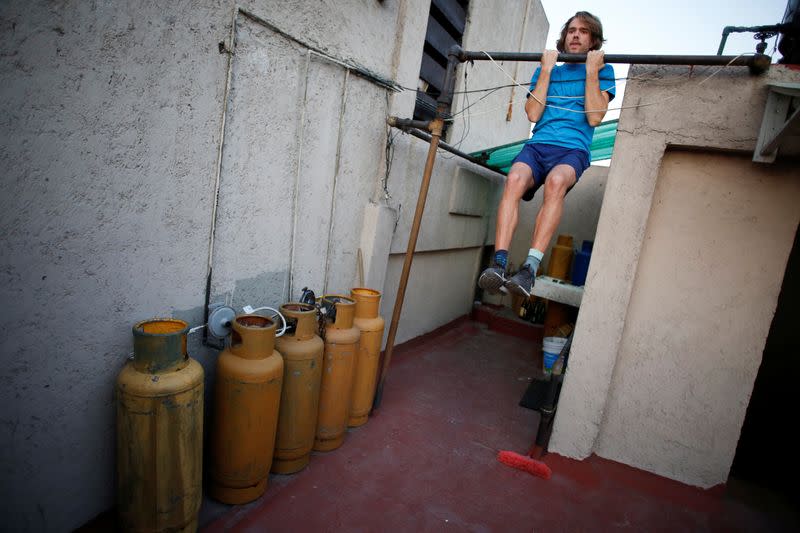 A man exercises on a roof as the spread of the coronavirus disease (COVID-19) continues in Mexico City