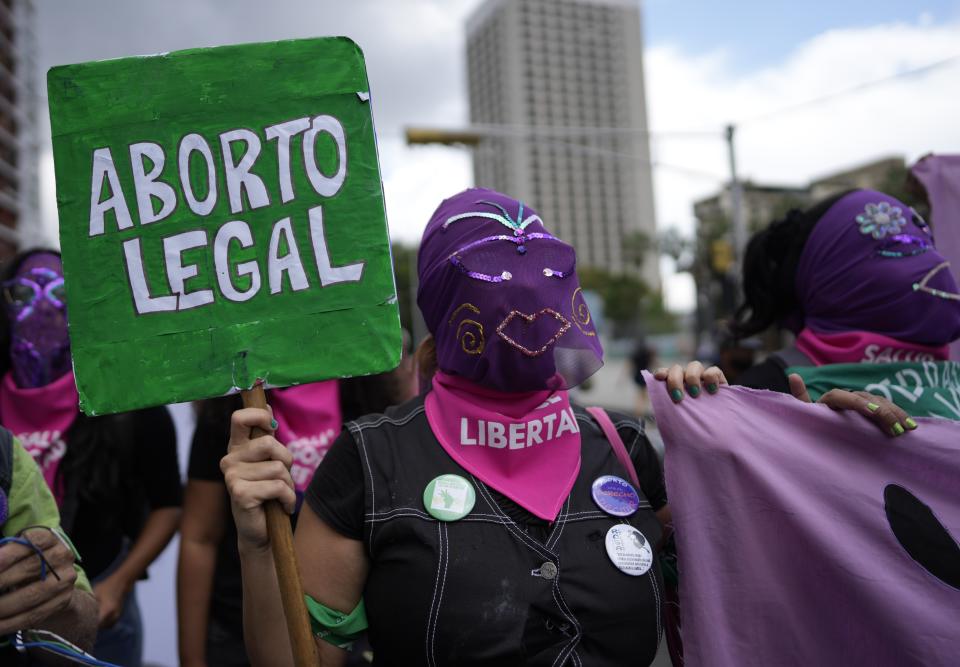 Women with their faces covered march during the the Global Day of Action for access to legal, safe and free abortion, at a square in Caracas, Venezuela, Tuesday, Sept. 28, 2021. (AP Photo/Ariana Cubillos)