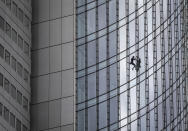 French urban climber Alain Robert, well known as "Spiderman", climbs down the 'Skyper' highrise in Frankfurt, Germany, Saturday, Sept. 28, 2019. (AP Photo/Michael Probst)