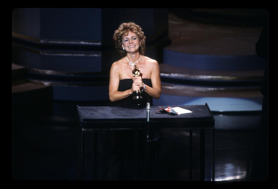 Sally Fields accepts the Best Performance by an Actress in a Supporting Role award for "Places in the Heart" onstage during the Oscars on March 25, 1985 in Hollywood, California