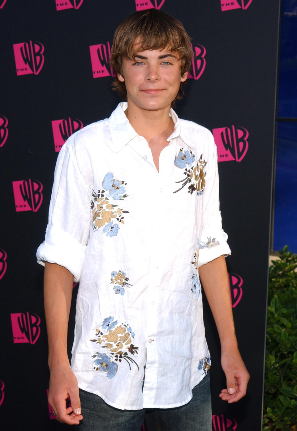 closeup of a younger him in a floral button down