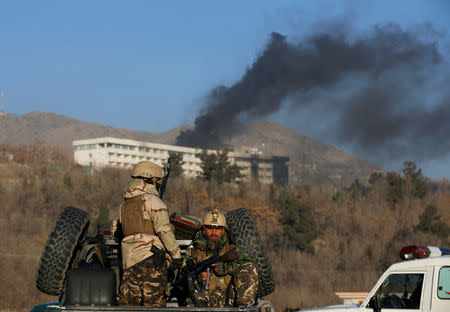 Afghan security forces keep watch as smoke rises from the Intercontinental Hotel in Kabul, Afghanistan, January 21, 2018. REUTERS/Omar Sobhani/Files