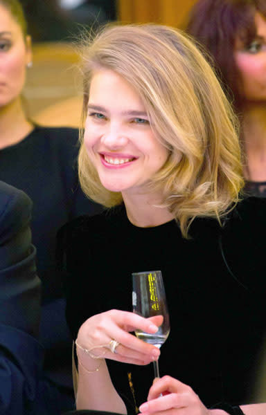 Natalia Vodianova sipped a glass of champagne as she sat stylish on the FROW for the Yanina collection © Rex