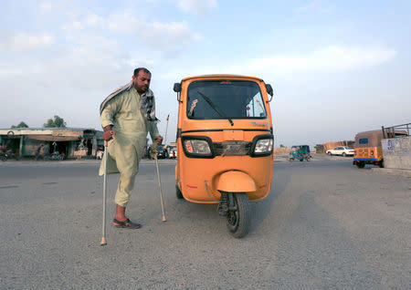 Bahader Khan 33, disable Afghan National Army (ANA) soldier walks next his rickshaw car in Jalalabad province, Afghanistan. August 2, 2017. REUTERS/Parwiz