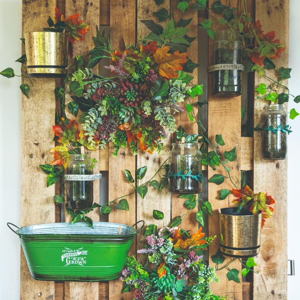 A garden wall with hanging planters