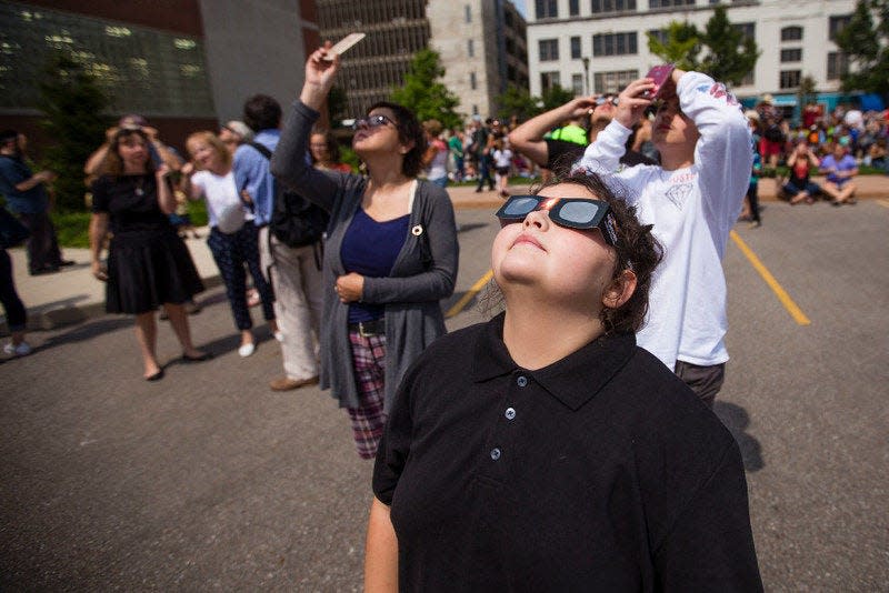 People gather to view the sun during a solar eclipse watch party in downtown South Bend in 2017.