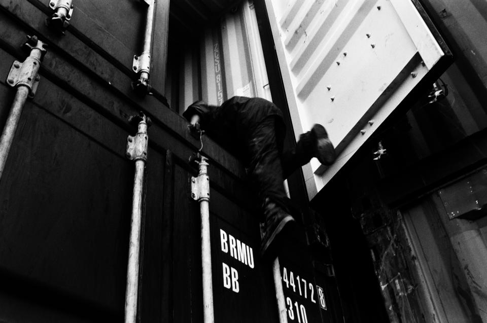 Mustafa, 11, climbs into a container heading for Melilla in the port of Tangier, Morocco, in 2003. (Photo: José Colón/MeMo for Yahoo News)