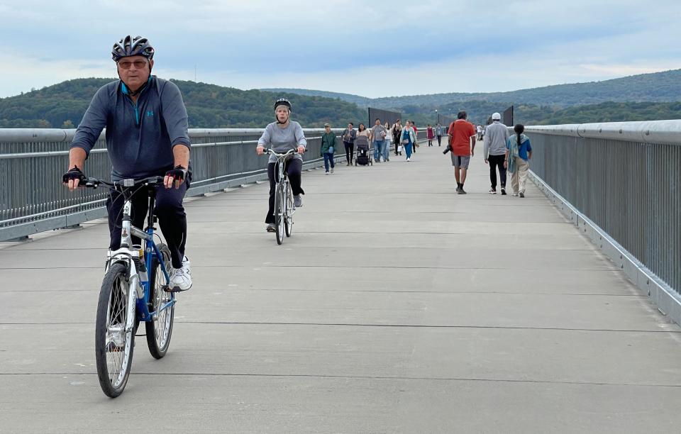 People enjoy riding their bicycles on the Walkway over the Hudson in Poughkeepsie.