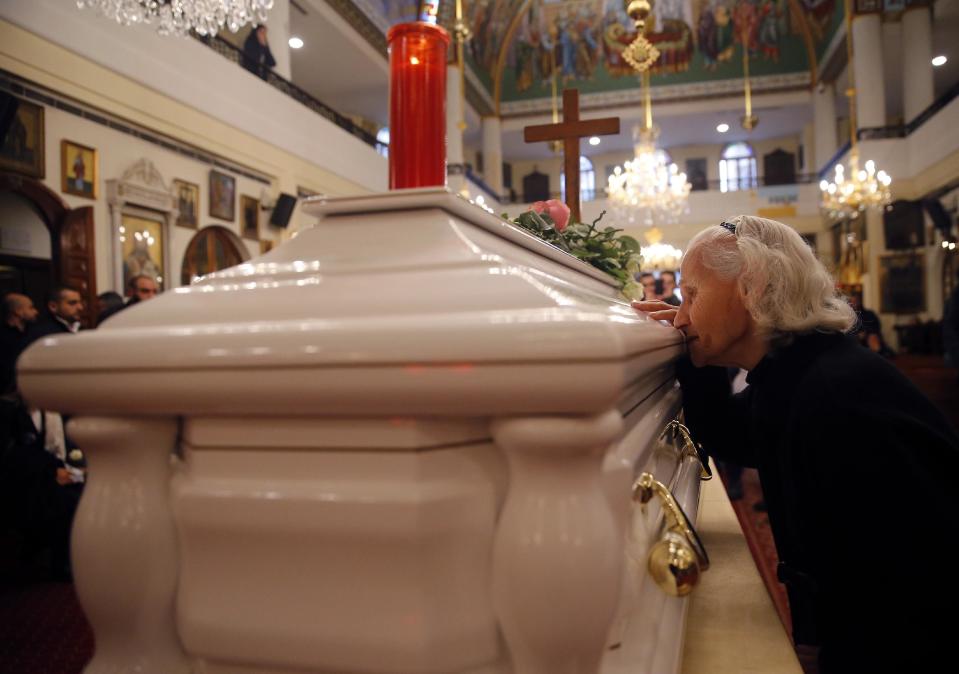 A relative woman of Elias Wardini, a Lebanese man who was killed in the New Year's Eve Istanbul nightclub attack, mourns over his coffin during the funeral, at a church in Beirut, Lebanon, Tuesday, Jan. 3, 2017. The gunman killed 39 people, most of them foreigners, including three Lebanese citizens, at the Istanbul nightclub. The Islamic State group claimed the attack on Monday, saying a "soldier of the caliphate" had carried out the mass shooting in response to Turkish military operations against IS in northern Syria. (AP Photo/Hussein Malla)