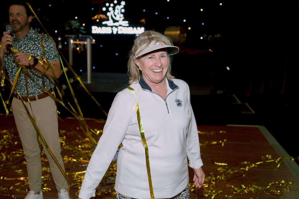 Mary Ruth Geny, of Tennessee, is honored after acing a hole-in-one challenge to win a new Porsche at the Nichols Cup Pro-Am Golf Tournament in February.