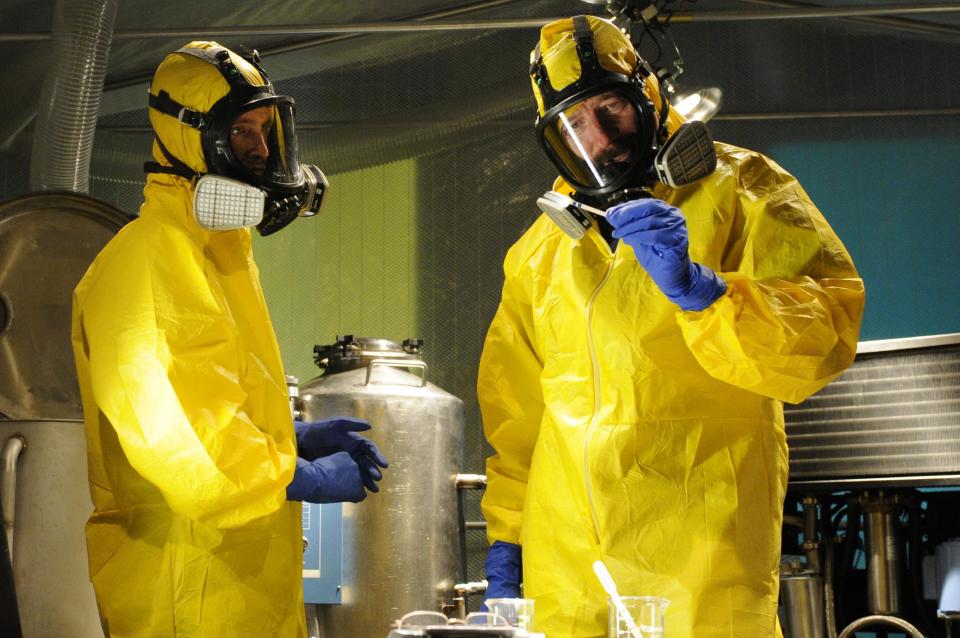 This image released by AMC shows Jesse Pinkman, played by Aaron Paul, left, and Walter White, played by Bryan Cranston, cooking meth in a home being fumigated in the fifth season of "Breaking Bad." The series finale of the popular drama series aired on Sunday, Sept. 29. (AP Photo/AMC, Ursula Coyote)