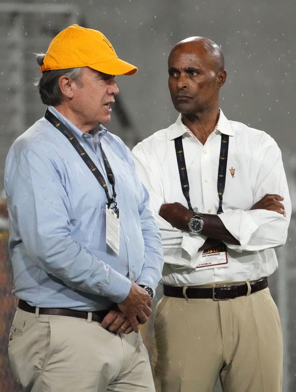 Arizona State president Michael Crow and vice president for university athletics Ray Anderson (right) talk as they watch the game against the Southern Utah Thunderbirds in the second half at Mountain America Stadium in Tempe on Sept. 1, 2023.