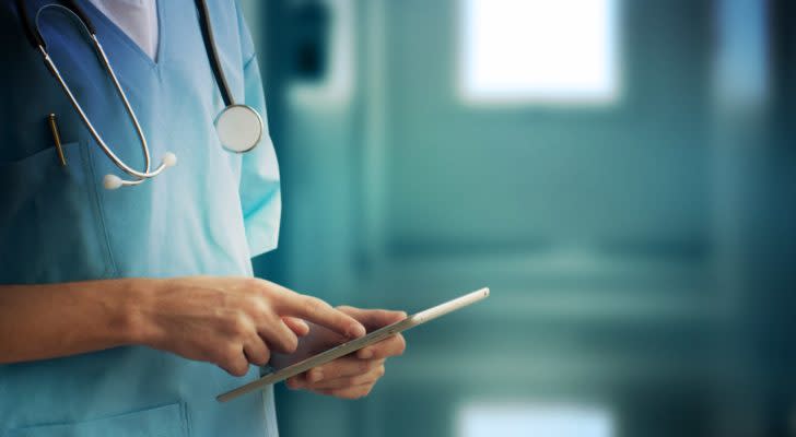 a doctor looks at a tablet