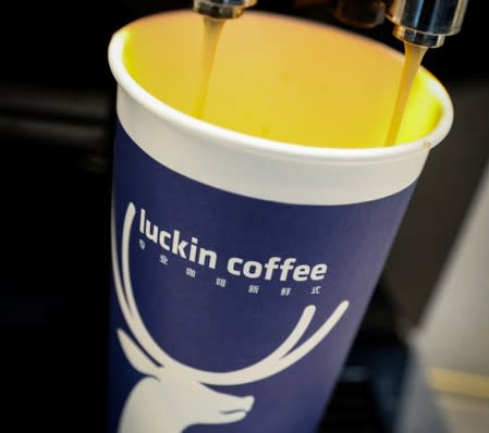 FILE PHOTO: A cup of 'Luckin Coffee,' coffee is poured during the company's IPO at the Nasdaq Market site in New York