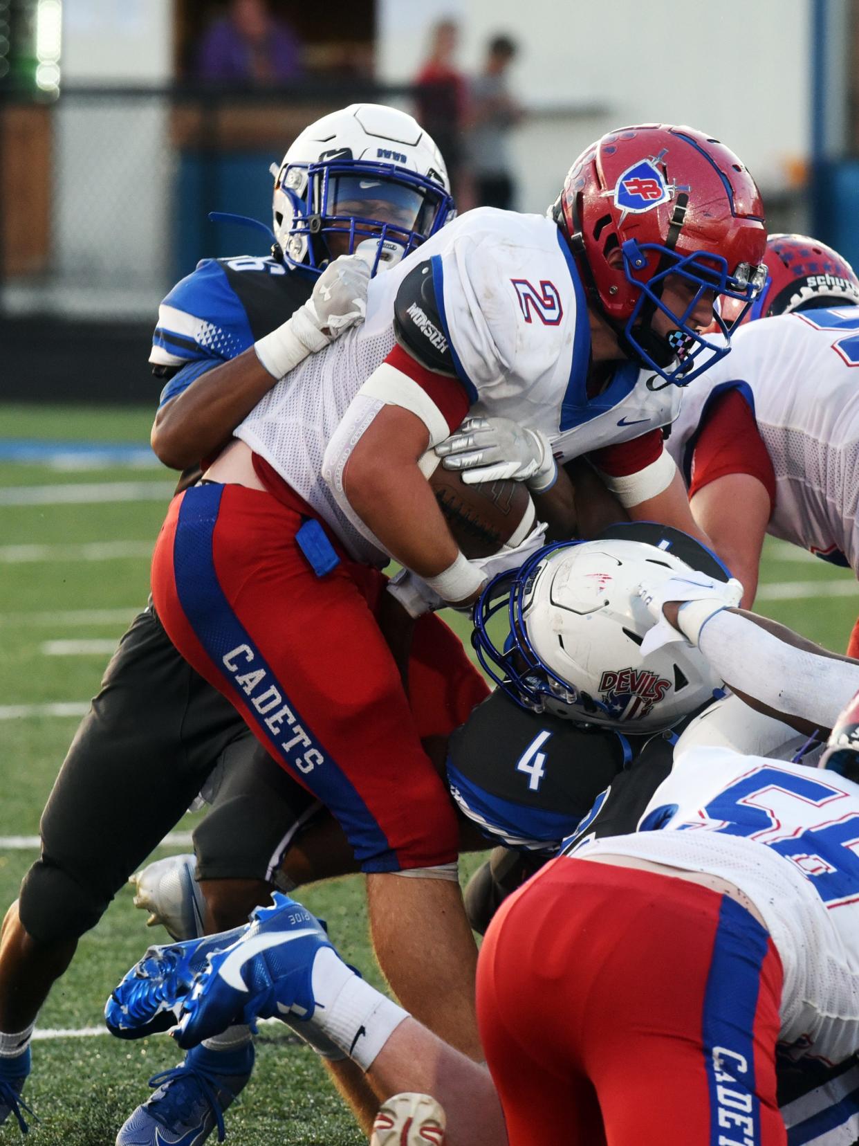 Dean Johnson, left, and Xavier Sowers brought down Owen Brown during Zanesville's loss to Fort Frye last season. Johnson and Sowers will lead the Blue Devils under first-year coach T.J. Langermeier.