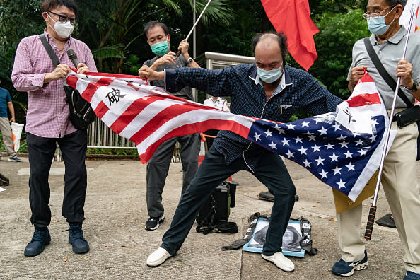 Chinese protesters tear up an American flag outside the Consulate General of the United States in Hong Kong on Wednesday, Aug. 3, 2022. <span class="copyright">Anthony Kwan/Getty Images</span>