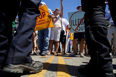 Law enforcement attempt to control demonstrators in Murrieta, California July 1, 2014. REUTERS/Sam Hodgson