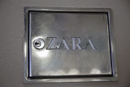 A Zara logo can be seen at the entrance of a Zara store, an Inditex brand, in central Madrid, Spain, March 8, 2016. REUTERS/Andrea Comas