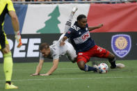 New England Revolution defender Jon Bell (23) clears the ball from the box ahead of CF Montreal midfielder Djordje Mihailovic (8) during the first half of an MLS soccer match, Sunday, July 25, 2021, in Foxborough, Mass. (AP Photo/Mary Schwalm)