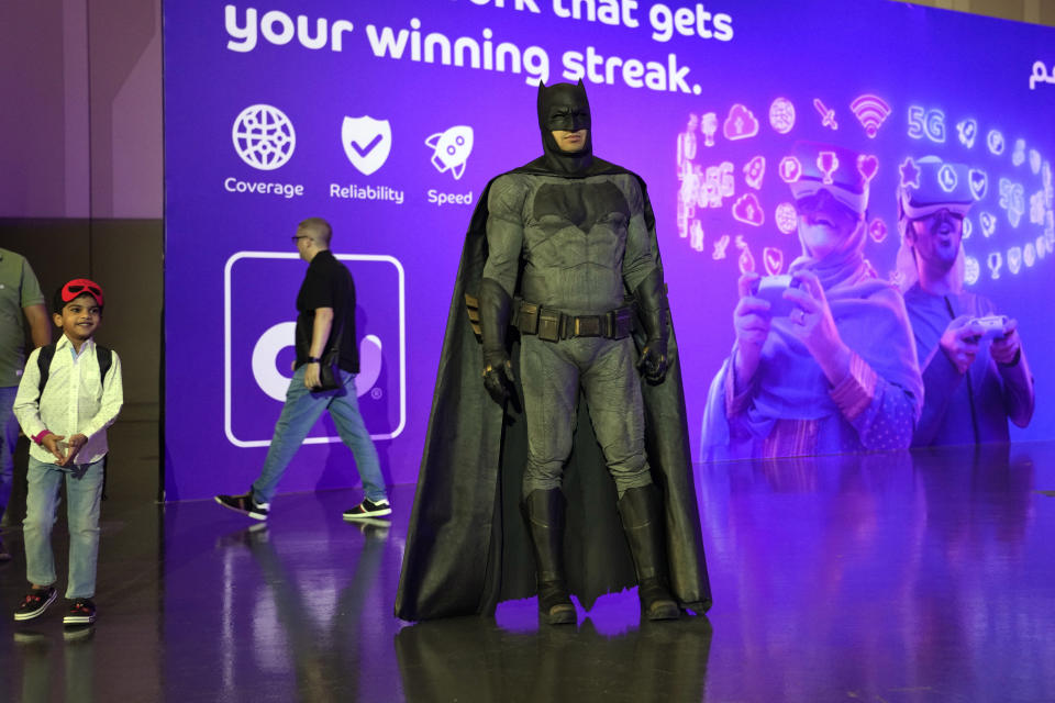 A gaming fan dressed in Batman outfit attends the Dubai Esports and Games Festival in Dubai, United Arab Emirates, Saturday, June 24, 2023. Saudi Arabia, the new home of some of soccer’s biggest stars and a co-owner of professional golf, is proving to be no less ambitious when it comes to another global pastime, the $180 billion-a-year video game industry. (AP Photo/Kamran Jebreili)