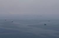 FILE PHOTO: Traditional boats known as dhows and cargo ships are seen sailing towards the Strait of Hormuz