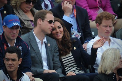 Britain's Duke of Cambridge William (L), Duchess of Cambridge Catherine (C) and Prince Harry (R) look on during the Jumping Phase of the Eventing competition of the 2012 London Olympics at the Equestrian venue in Greenwich Park, London, on July 31, 2012