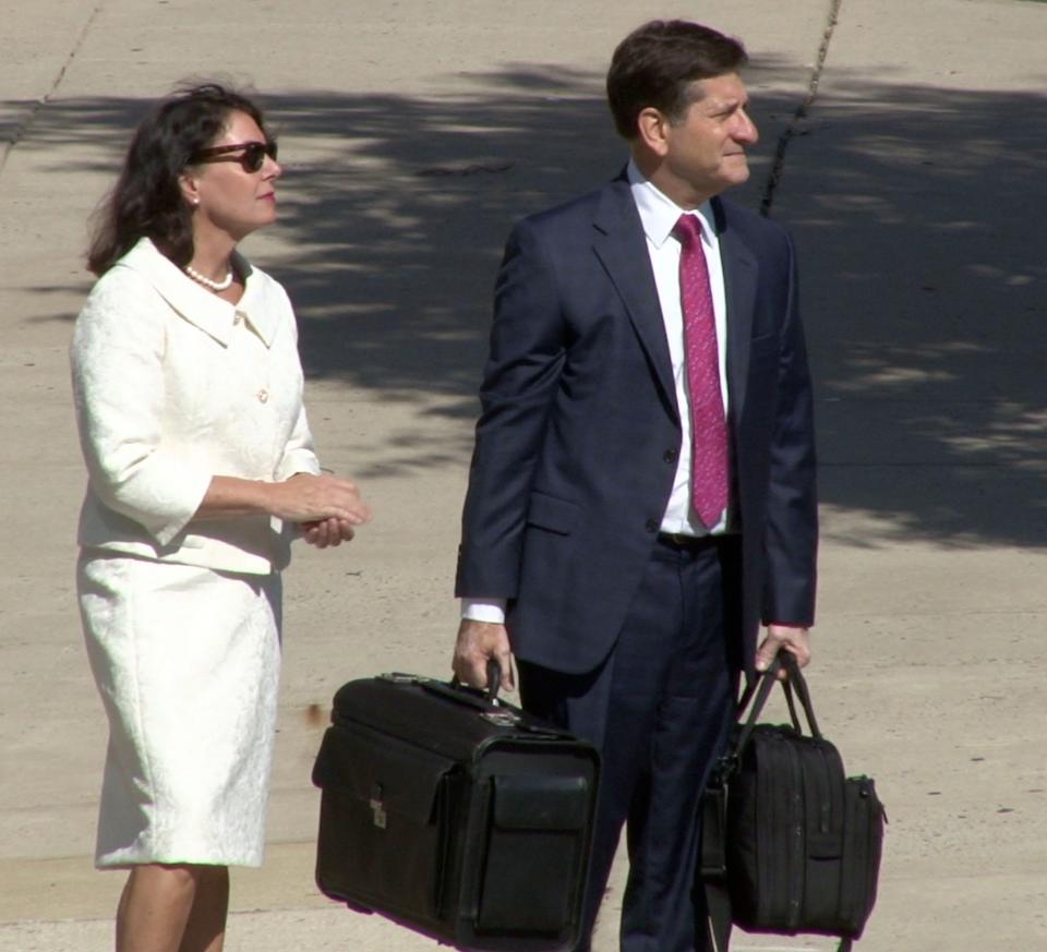 State Auditor Kathy McGuiness (left) waits to cross N. Market St. with Steve Wood, her attorney ahead of Tuesday's trial proceedings.