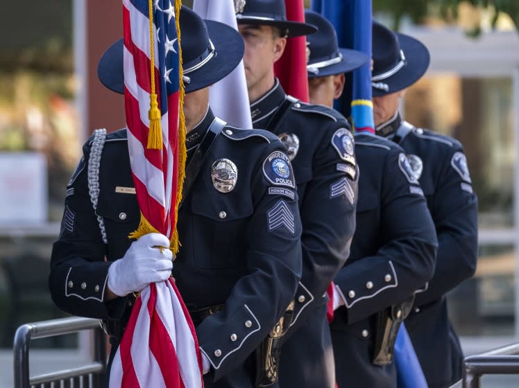 MURRIETA, CA - AUGUST 31: The Murrieta Police Department Honor Guard line up at the Town Square Park Amphitheater to honor three Southern California Marines, including two from Riverside County, who were among 13 service members killed in a suicide bombing at Hamid Karzai International Airport in Kabul on Tuesday, Aug. 31, 2021 in Murrieta, CA. On Tuesday, the city of Murrieta will honor all 13 service members who lost their lives in the Thursday bombing, including Cpl. Hunter Lopez, 22, of Indio, Lance Cpl. Kareem Mae'Lee Grant Nikoui, 20, of Norco, and Lance Cpl. Dylan Merola, 20, of Rancho Cucamonga. All three were assigned to 2nd Battalion, 1st Marine Regiment, 1st Marine Division, I Marine Expeditionary Force at Camp Pendleton. The "Remembrance Ceremony Honoring Fallen Service Members" (Francine Orr / Los Angeles Times)