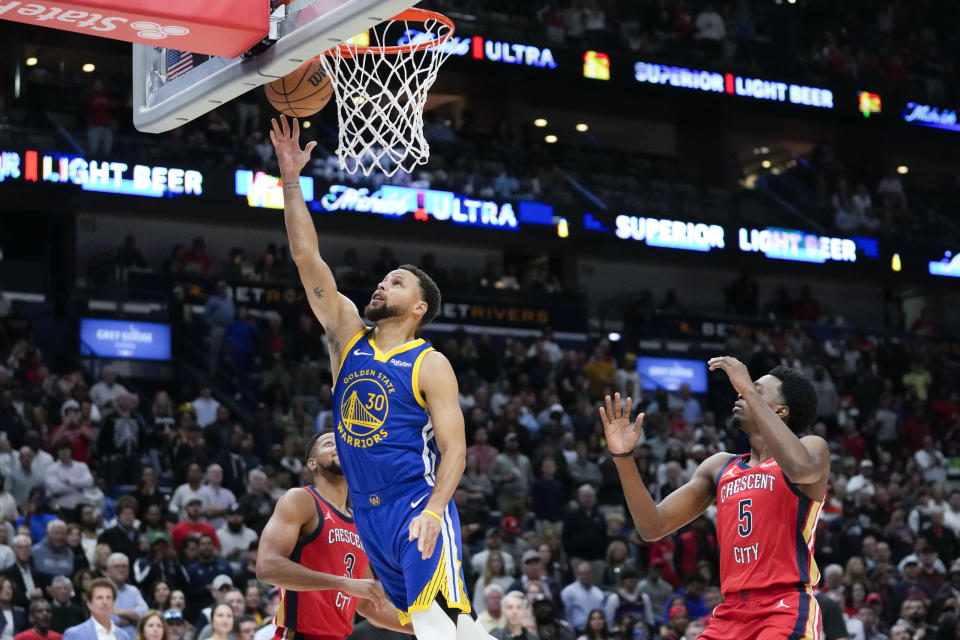 Golden State Warriors guard Stephen Curry (30) goes to the basket against New Orleans Pelicans forward Herbert Jones (5) in the first half of an NBA basketball game in New Orleans, Monday, Oct. 30, 2023. (AP Photo/Gerald Herbert)