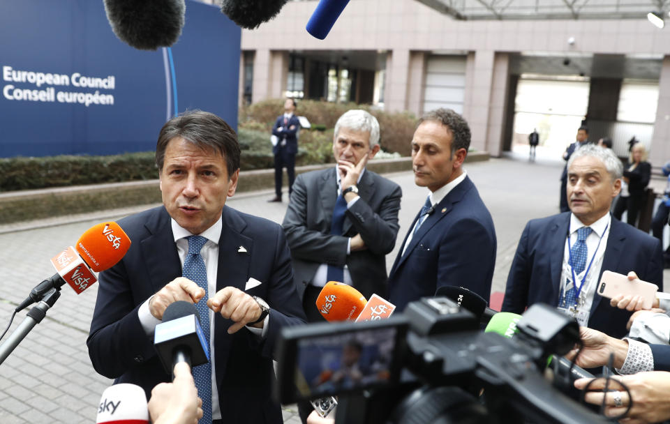 Italian Prime Minister Giuseppe Conte speaks with the media as he departs an EU-ASEM summit in Brussels, Friday, Oct. 19, 2018. EU leaders met with their Asian counterparts Friday to discuss trade, among other issues. (AP Photo/Alastair Grant)