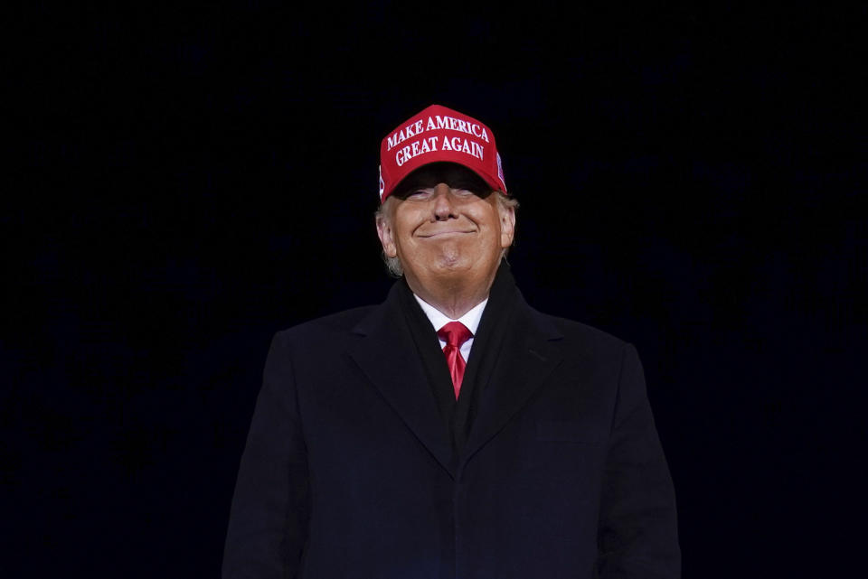 President Donald Trump smiles at supporters after a campaign rally at Gerald R. Ford International Airport, early Tuesday, Nov. 3, 2020, in Grand Rapids, Mich. (AP Photo/Evan Vucci)