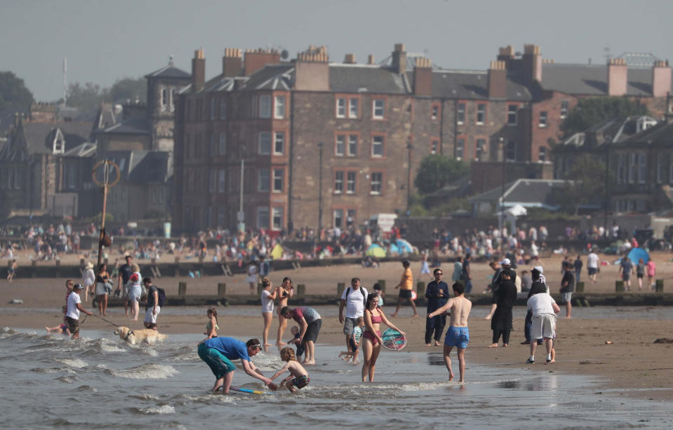People enjoying the weather on Portobello Beach in Edinburgh.