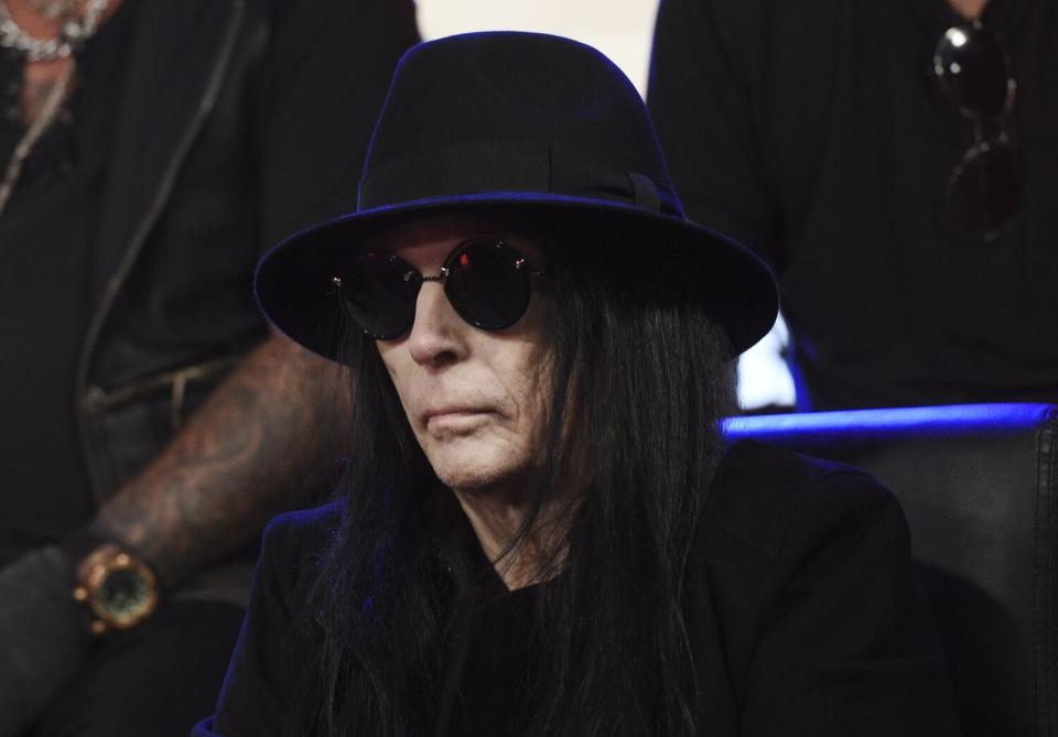 Mick Mars of Mötley Crüe wearing a large hat and dark sunglasses