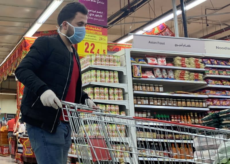 A man carries disinfectant inside a Carrefour hypermarket while Egypt ramps up its efforts to slow the spread the coronavirus disease (COVID-19) in Cairo