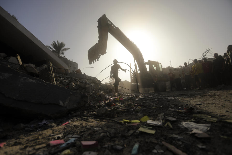 Palestinians look for survivors following an Israeli airstrike in Khan Younis refugee camp, southern Gaza Strip, Tuesday, Nov. 7, 2023. (AP Photo/Mohammed Dahman)