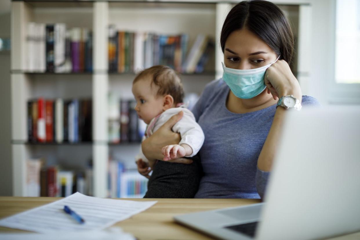 <span class="caption">For parents during the pandemic, juggling hasn't been an option: It's both work and family, all the time.</span> <span class="attribution"><a class="link " href="https://www.gettyimages.com/detail/photo/worried-mother-with-face-protective-mask-working-royalty-free-image/1217382268" rel="nofollow noopener" target="_blank" data-ylk="slk:damircudic/E+ via Getty Images;elm:context_link;itc:0;sec:content-canvas">damircudic/E+ via Getty Images</a></span>