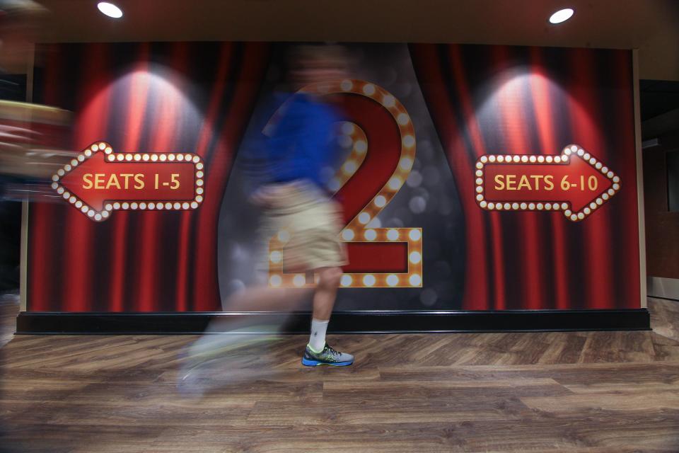 A customer walks to an auditorium at Main Street Movies 5 in Newark in March of 2017.