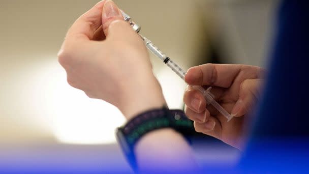 PHOTO: A nurse fills up syringes with the coronavirus disease (COVID-19) vaccines for residents who are over 50 years old and immunocompromised and are eligible to receive their second booster shots in Waterford, Mich., April 8, 2022.   (Emily Elconin/Reuters, FILE)