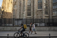 Piotr Grabarczyk and his boyfriend Kamil Pawlik, right, walk by the Sagrada Familia basilica in Barcelona, Spain, Thursday, July 30, 2020. Grabarczyk and Pawlik are starting over in Spain, a country that — unlike Poland — allows same-sex couples the right to marry and adopt children. Like them, many LGBT people are choosing to leave Poland amid rising homophobia promoted by President Andrzej Duda and other right-wing populist politicians in power. (AP Photo/Felipe Dana)