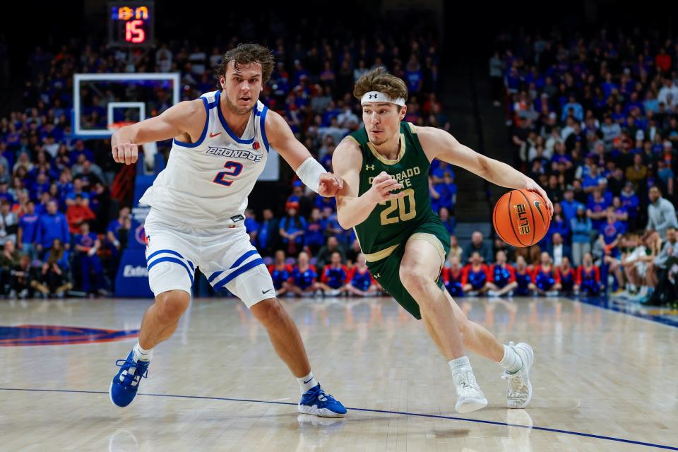 Colorado State guard Joe Palmer (20) drives toward the basket against Boise State forward O'Mar Stanley (1) in the first half of an NCAA college basketball game Tuesday, Jan. 9, 2024, in Boise, Idaho. (AP Photo/Steve Conner)