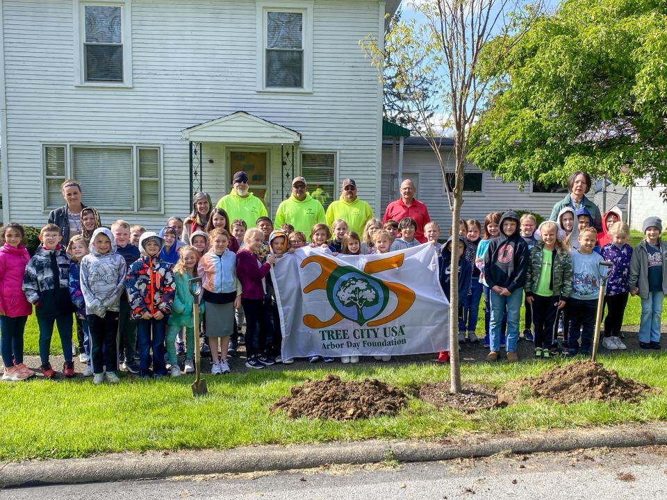 Students from Ms. Dolan's and Ms. Pollock's class help plant a Japanese Zelkova for New Concord's recognition as a Tree City, USA designee.